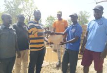 Thomas Agoalisui making the donation on behalf of James Agalga
