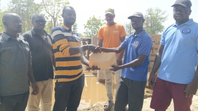 Thomas Agoalisui making the donation on behalf of James Agalga