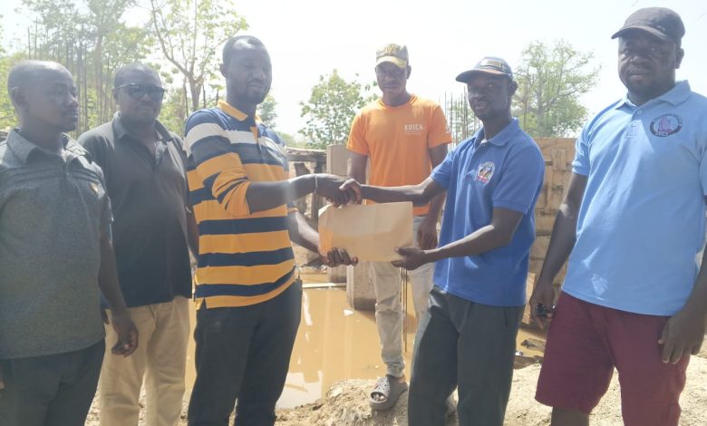 Thomas Agoalisui making the donation on behalf of James Agalga