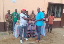 Chief Kanfosi Felix Achaab handing over the donated items to the Prison's Officials.